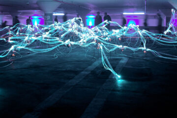 Credentials Unbound - Picture shows an art installation in an open space with wires and lights connecting to each other resembling lightning across the floor