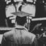 Online Students Make Great Alumni - Picture of graduate in cap and gown standing in an arena, black and white photo